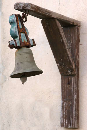 old doorbell hanging from a white wallの写真素材