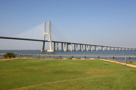 View of one of Lisbon's bridges with a grass lawn in foreground