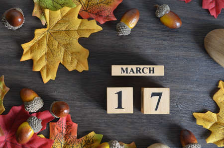 March 17, Cover Date design with Calendar cube decorate with maple leaf and Acorn Oak seed for your business.の写真素材