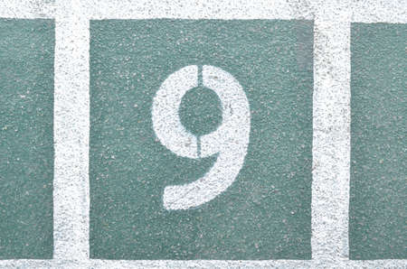 Number 9 on the green cement floor.の写真素材