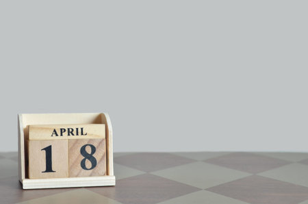 April 18, Empty Background with number cube on the diamond wooden table.の写真素材