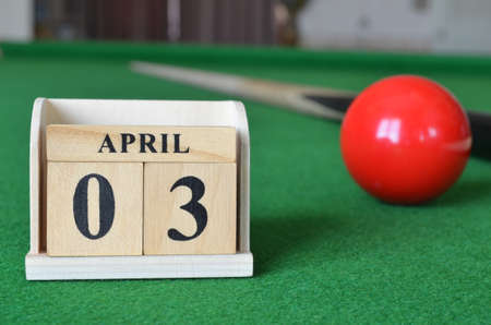 April 3, number cube with balls on a snooker table, sports background.の写真素材