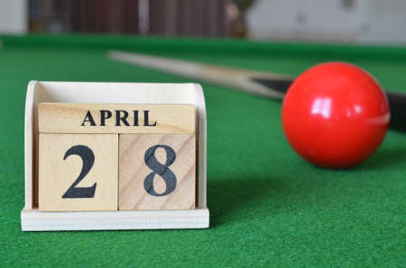 April 28, number cube with balls on a snooker table, sports background.の写真素材