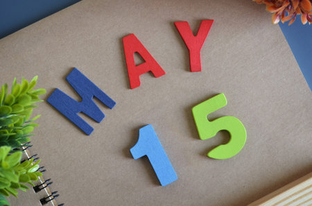 May 15, Cover design in natural concept with a brown notebook and colorful wooden alphabet.の写真素材