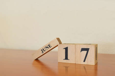 June 17, Date design with calendar cube on wooden table and white background.の写真素材