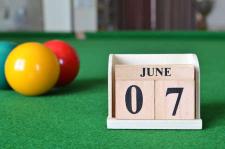 June 7, number cube with balls on snooker table, sport background.の写真素材