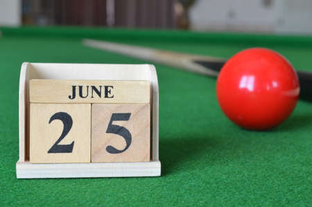 June 25, number cube with balls on snooker table, sport background.の写真素材