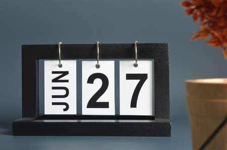 June 27, Date design with a black wooden calendar for a business, Date Plans to remind.の写真素材