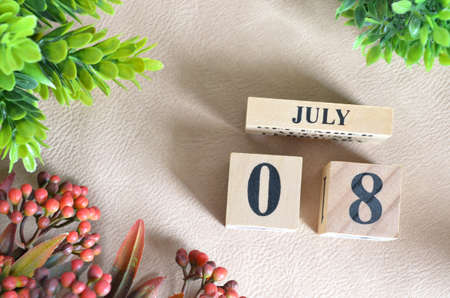 July 8. Number cube in natural concept on white leather for the backgroundの写真素材