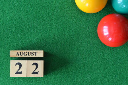 August 22, number cube with balls on snooker table, sport background.の写真素材