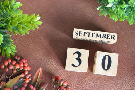 September 30. Number cube in natural concept on brown leather for the backgroundの写真素材