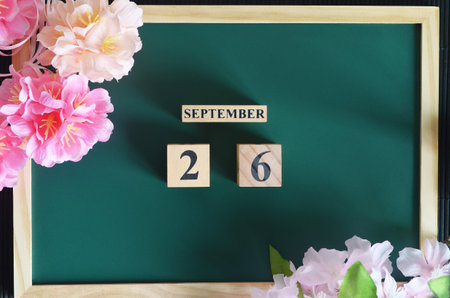 September 26, Japanese Cover, Number cube with sakura flower on the wood green board.の写真素材