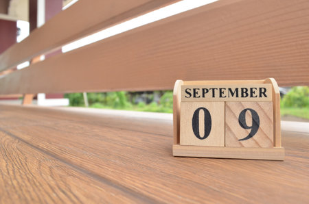 September 9, Number cube with wooden balcony background.の写真素材