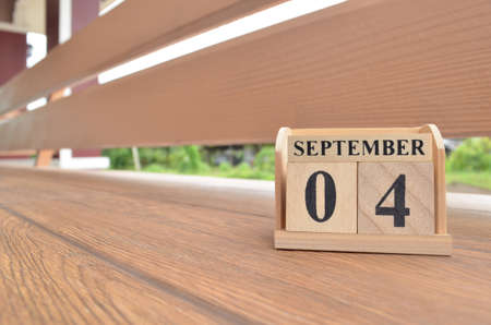 September 4, Number cube with wooden balcony background.の写真素材