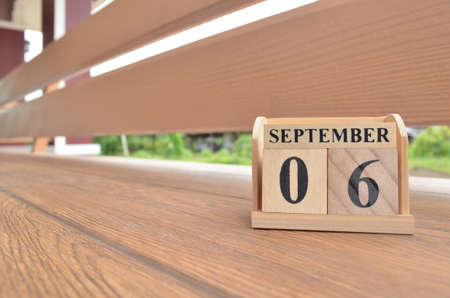 September 6, Number cube with wooden balcony background.の写真素材