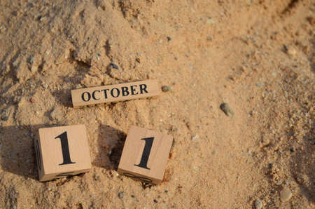 October 11, Number cube with a Sand background.の写真素材