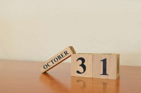 October 31, Date design with calendar cube on wooden table and white background.の写真素材