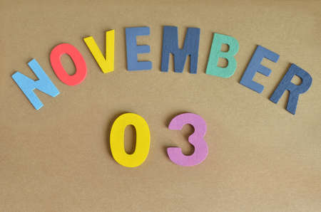 November 3, Toy alphabet with a brown background.の写真素材