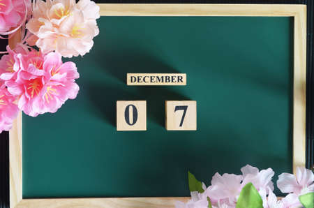 December 7, Japanese Cover, Number cube with sakura flower on the wood green board.の写真素材
