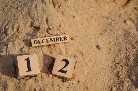 December 12, Number cube with a Sand background.の写真素材