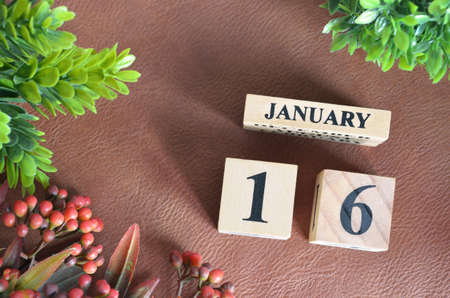 January 16. Number cube in natural concept on brown leather for the backgroundの写真素材