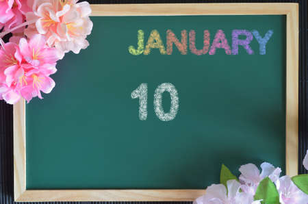 January 10, month write with colorful chalk, flowers on the board.の写真素材