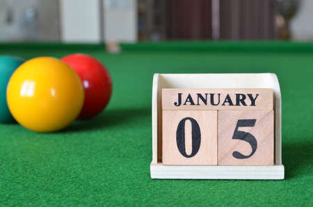 January 5, number cube with balls on snooker table, sport background.の写真素材