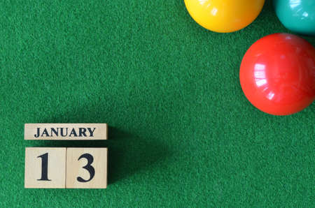 January 13, number cube with balls on snooker table, sport background.の写真素材