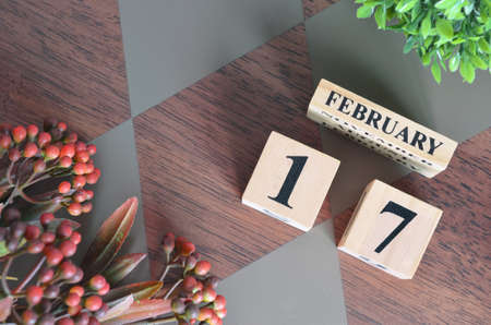 February 17. Date of February month. Number Cube with a flower and leaves on Diamond wood table for the backgroundの写真素材