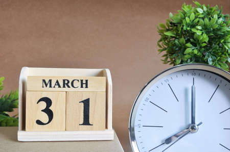March 31, Cover design with silver - white clock in the natural concept.の写真素材