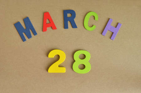 March 28, Toy alphabet with a brown background.の写真素材