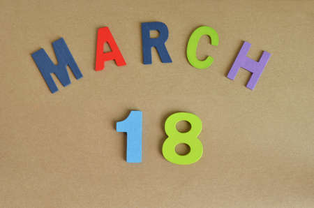 March 18, Toy alphabet with a brown background.の写真素材