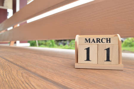 March 11, Number cube with wooden balcony background.の写真素材