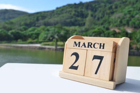 March 27, Date design with number cube on white table, cover design in the natural concept.の写真素材