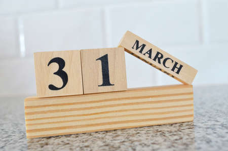 March 31, Cover design with number cube on a white background and granite table.の写真素材