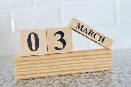 March 3, Cover design with number cube on a white background and granite table.の写真素材