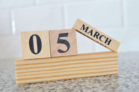 March 5, Cover design with number cube on a white background and granite table.の写真素材