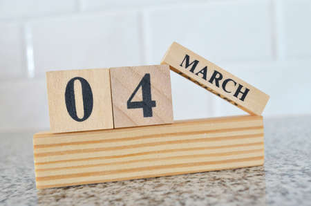 March 4, Cover design with number cube on a white background and granite table.の写真素材