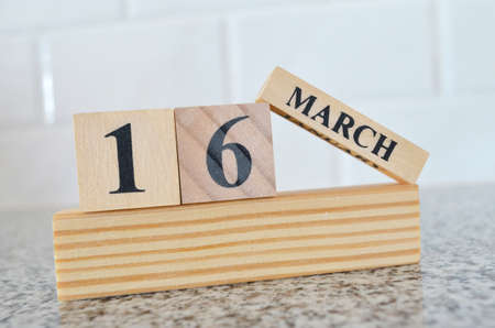 March 16, Cover design with number cube on a white background and granite table.の写真素材