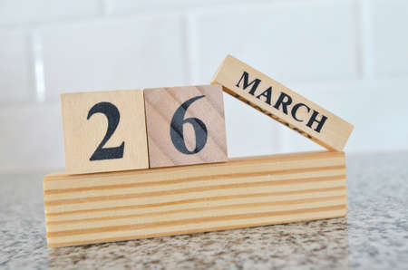 March 26, Cover design with number cube on a white background and granite table.の写真素材