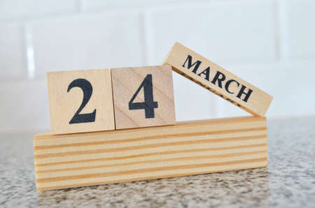 March 24, Cover design with number cube on a white background and granite table.の写真素材