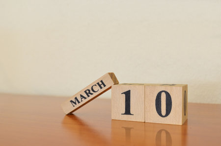 March 10, Date design with calendar cube on wooden table and white background.の写真素材