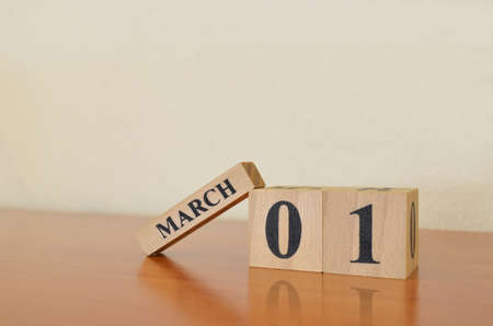 March 1, Date design with calendar cube on wooden table and white background.の写真素材