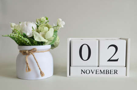 November 2, Cover natural background, white wooden Calendar cube with a pot flower on white background.の写真素材