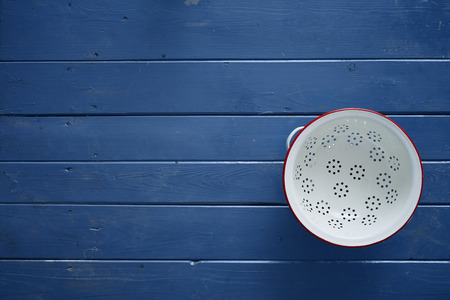 white and red sieve on blue wooden tableの写真素材