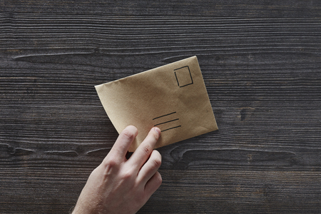 hand picking up unadressed letterの写真素材