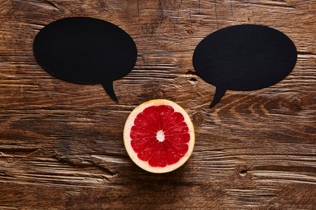 sliced ??organic grapefruit with two speech bubbles