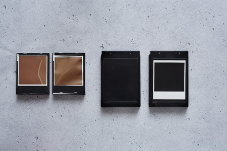 four instant film cassettes hanging on a wallの写真素材