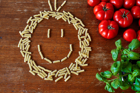a bunch of pasta tomatoes and herbs giving space