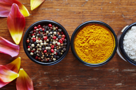 kurkuma and pepper in black bowls asian cuisineの写真素材